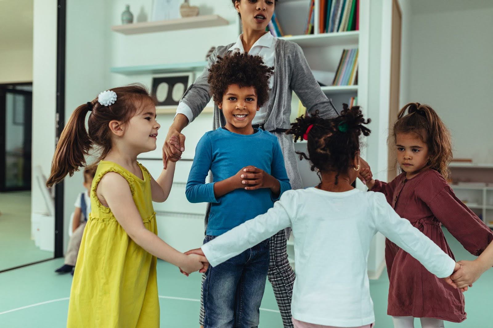 ABA Therapist working with a group of young children on social interaction