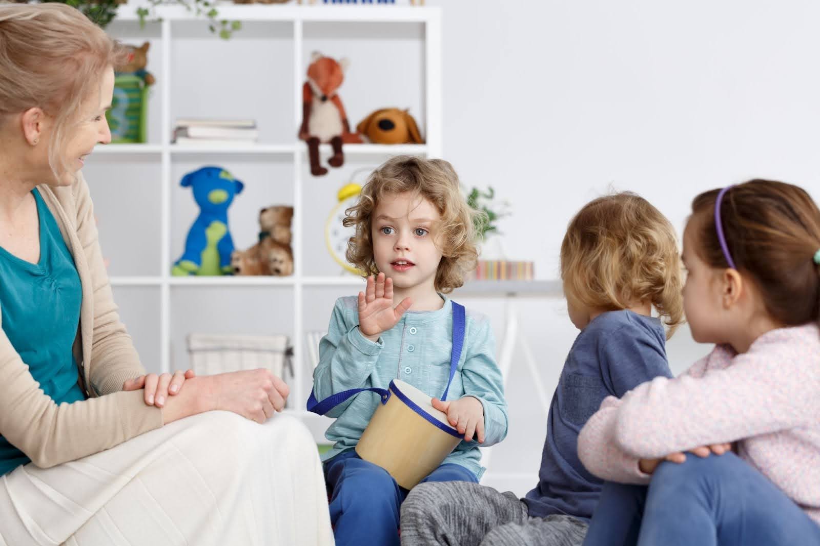 ABA therapist working with young kids on social interactions.