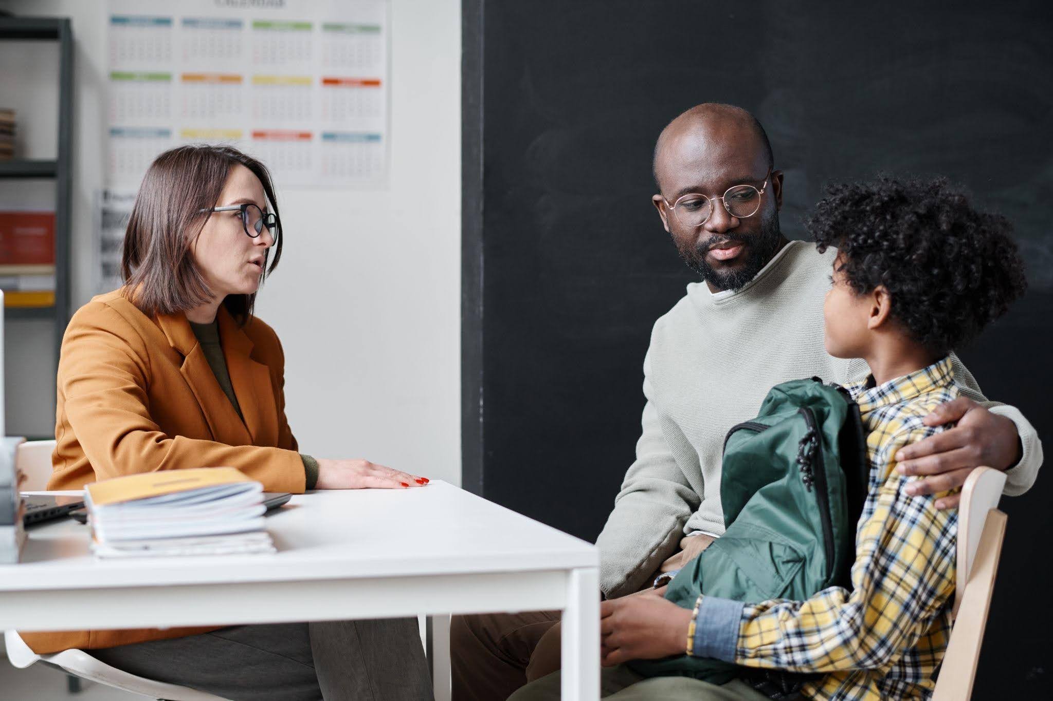 Parent meeting with teacher to discuss a child’s IEP at school